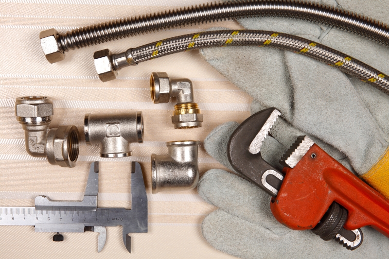 Plumber working on pipes in a South Lambeth home